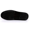 Black rubber sole of antiskid slip-on loafer shoes with textured grip for enhanced traction and durability.