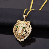 Gold tiger head pendant with green stones and intricate diamond-like detailing, perfect for bold jewelry statements.