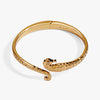Gold seahorse bypass cuff bracelet with textured detailing and a hinged closure. Perfect for ocean-inspired jewelry lovers.